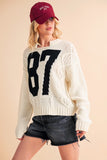 Anokhinaliza Aemi+Co Contrast Number Cable Knit Drop Shoulder Sweater