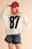 Anokhinaliza Aemi+Co Contrast Number Cable Knit Drop Shoulder Sweater