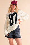 Anokhinaliza Aemi+Co Contrast Number Cable Knit Drop Shoulder Sweater